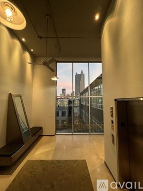 Columbus condo for rent - A hallway with a large window overlooking a cityscape.