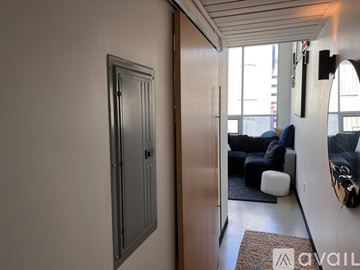 Columbus condo for rent - A living room with a grey couch, a black chair, and a painting on the wall.