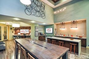 St. Petersburg apartment for rent - A modern kitchen with a wooden table and bar stools.