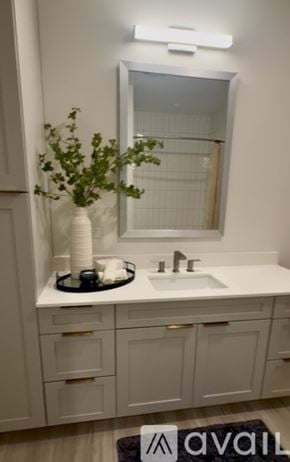 Tampa apartment for rent - A modern bedroom with a bed, couch, and television.