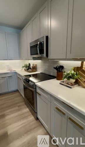 Tampa apartment for rent - A modern building with a pool and lounge chairs.