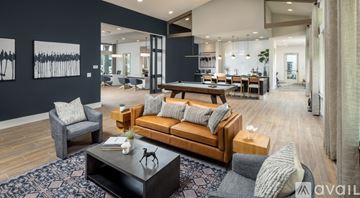 Tampa townhouse for rent - A modern living room with a dark blue rug and a wooden coffee table.