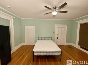 Cambridge apartment for rent - A room with a bed and a window with blinds.