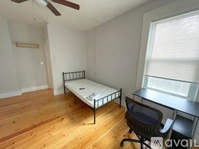 Cambridge apartment for rent - A kitchen with a washing machine and a stove top.