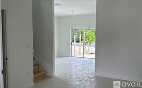 Miami-Dade County townhouse for rent - A room with a tiled floor and a door leading to a balcony.