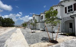 Miami-Dade County townhouse for rent - A row of houses with trees in front of them.