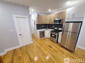 Brooklyn apartment for rent - A kitchen with wooden floors and stainless steel appliances.