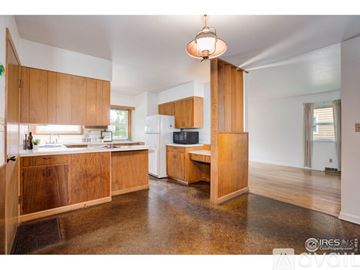 Fort Collins house for rent - A kitchen with wooden cabinets and a white refrigerator.