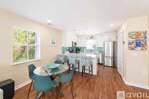 Key West condo for rent - A dining room with a glass table and chairs.