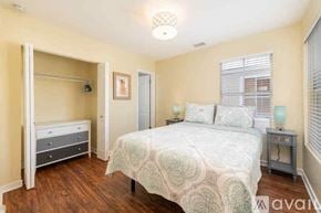 Key West condo for rent - A bedroom with a bed, nightstand, and a dresser.