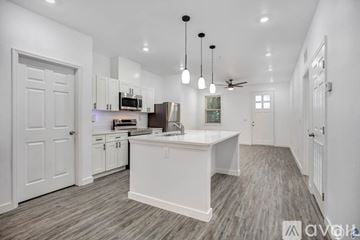 Tampa apartment for rent - A modern kitchen with white cabinets and a central island.