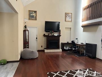 Orlando apartment for rent - A living room with a fireplace and a television on a stand.