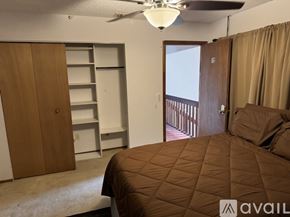 Orlando apartment for rent - A bedroom with a brown bed and a brown wardrobe.