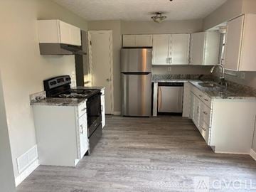 Westerville house for rent - A kitchen with a stainless steel refrigerator and oven.