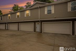Kalamazoo apartment for rent - A row of houses with garages in front.