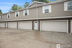Kalamazoo apartment for rent - A row of houses with garages in front.
