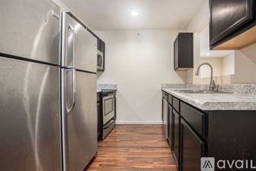 Kalamazoo apartment for rent - A kitchen with a stainless steel refrigerator and a marble countertop.