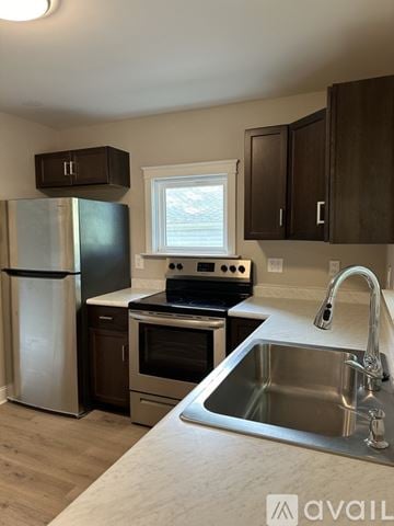 Lansing house for rent - A kitchen with a stainless steel sink and a window.
