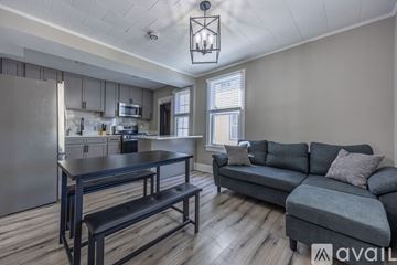 Brentwood apartment for rent - A kitchen with a table and a couch in the living room.