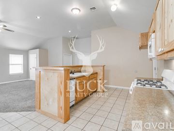 Midwest City house for rent - A kitchen area with a countertop and cabinets is shown.