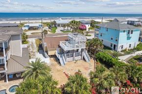 Fernandina Beach townhouse for rent - A bird's eye view of a beachfront property with a pool and a house with a blue roof.