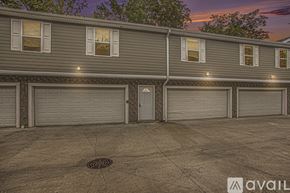 Kalamazoo townhouse for rent - A building with a row of garage doors in front of it.