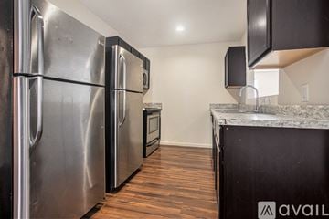 Kalamazoo townhouse for rent - A kitchen with a stainless steel refrigerator and a granite countertop.