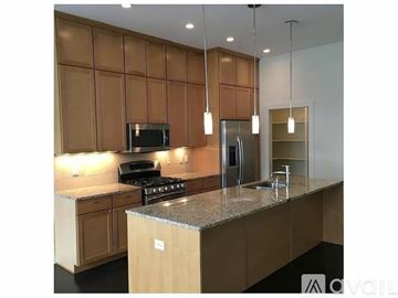Indianapolis house for rent - A kitchen with brown cabinets and a granite countertop.