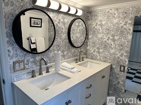 Gordonsville apartment for rent - A bathroom with a sink, mirror, and lighting fixture.