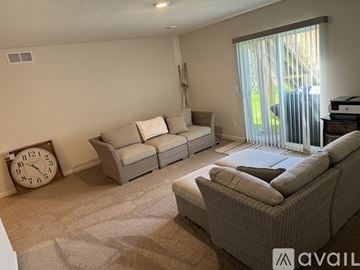 Montrose house for rent - A living room with a sofa set and a clock on the wall.