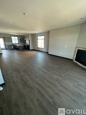 North Mankato apartment for rent - A spacious living room with wooden flooring and a fireplace.