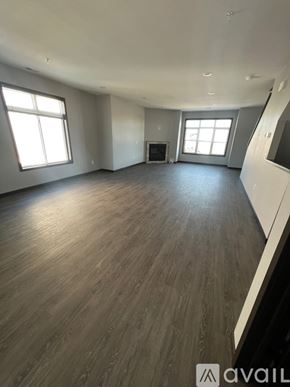 North Mankato apartment for rent - A spacious room with wooden flooring and a fireplace.