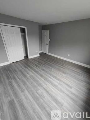 Blackwood apartment for rent - A room with grey walls and wooden flooring with two doors.