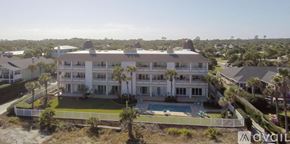 Atlantic Beach condo for rent - A large white house with a pool in the front yard.