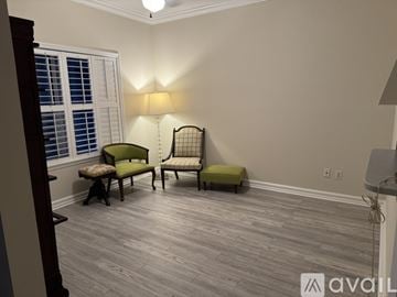 Atlantic Beach condo for rent - A living room with a green chair and a bench.