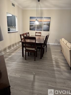 Atlantic Beach condo for rent - A dining room with a wooden table and chairs.