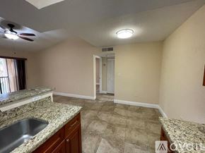 Miami apartment for rent - A kitchen with a sink and a ceiling fan.