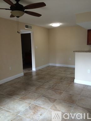Miami apartment for rent - A room with a ceiling fan and tile flooring.