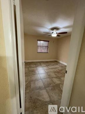 Miami apartment for rent - A room with a ceiling fan and tile flooring.