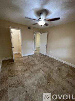 Miami apartment for rent - A room with a ceiling fan and tile flooring.