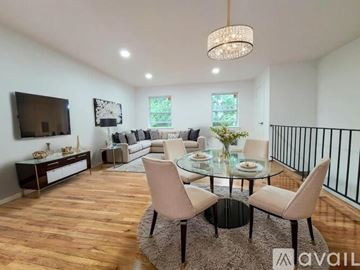 North Brunswick Township apartment for rent - A modern living room with a glass table and chairs.