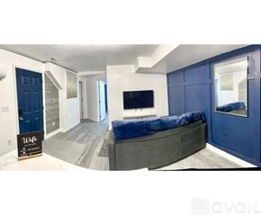 Cincinnati apartment for rent - A living room with a blue couch and a television.