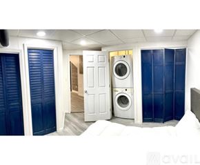 Cincinnati apartment for rent - A white door is open to a hallway with a washing machine in the background.