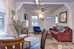 Hampton house for rent - A living room with a red couch and a glass table.
