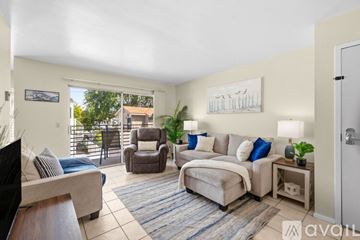 San Diego condo for rent - A living room with a couch, chair, and a painting on the wall.
