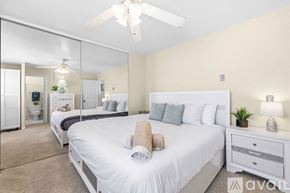San Diego condo for rent - A kitchen with wooden cabinets and a black microwave above the stove.