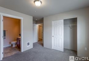 Spokane Valley apartment for rent - A spacious room with a toilet and sink visible through an open door.