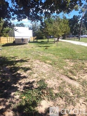 Bastrop apartment for rent - A white trailer is parked in a grassy field.