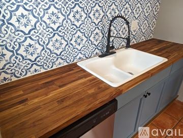 St. Petersburg house for rent - A kitchen with a sink and a wallpapered backsplash.