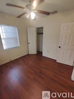 Coral Gables house for rent - A room with a ceiling fan and wooden flooring.
